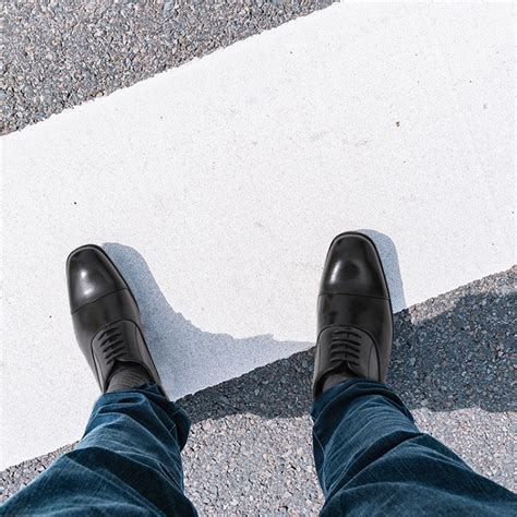 blue jeans with black oxfords.